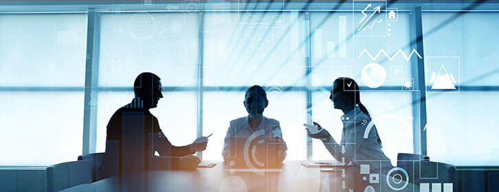 Three people at a conference table