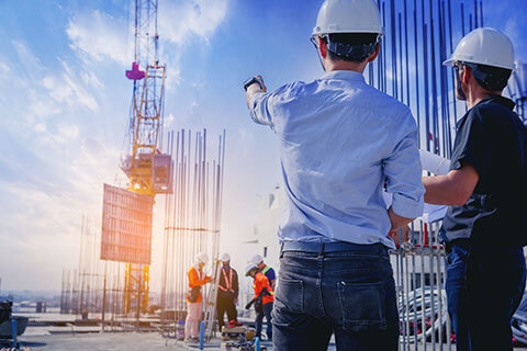 Two men in hardhats at a construction site