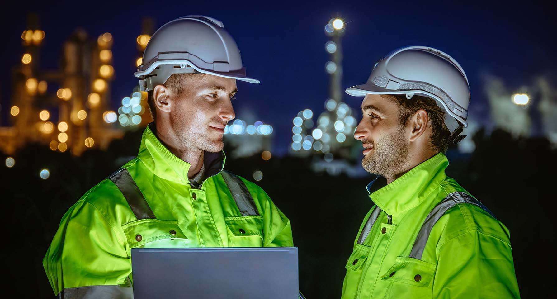 Field Service workers outside plant with laptop